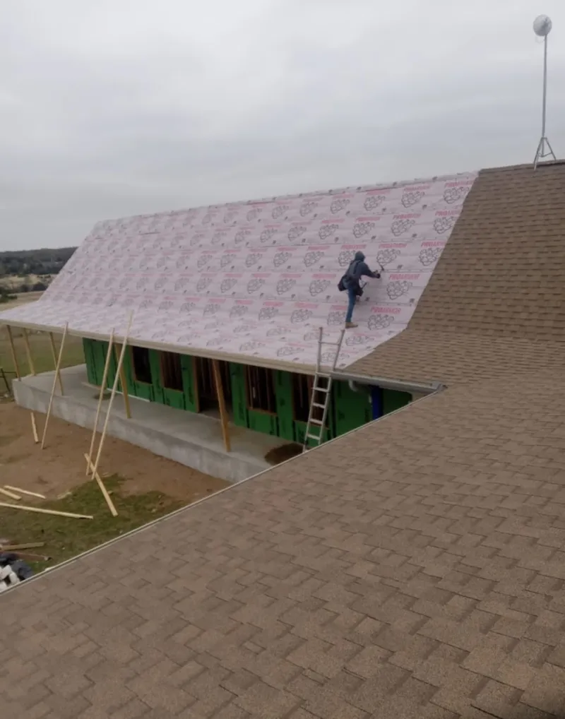 Worker preparing underlayment for a metal roof installation in Cape Canaveral